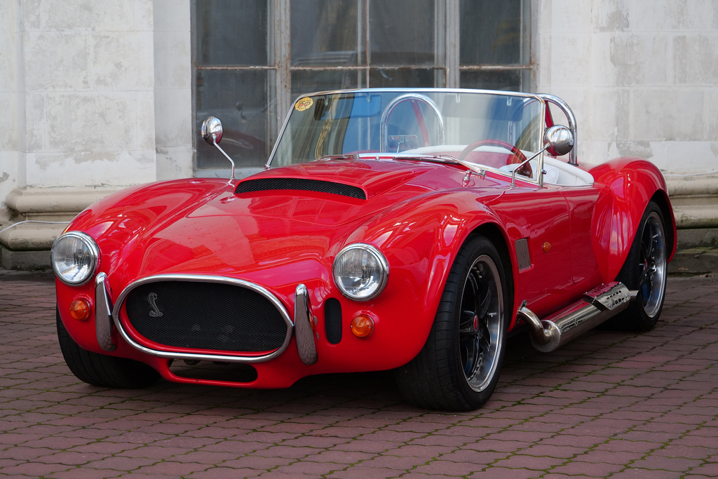 Red retro car Shelby Cobra stands at central Expo Center in Kyiv